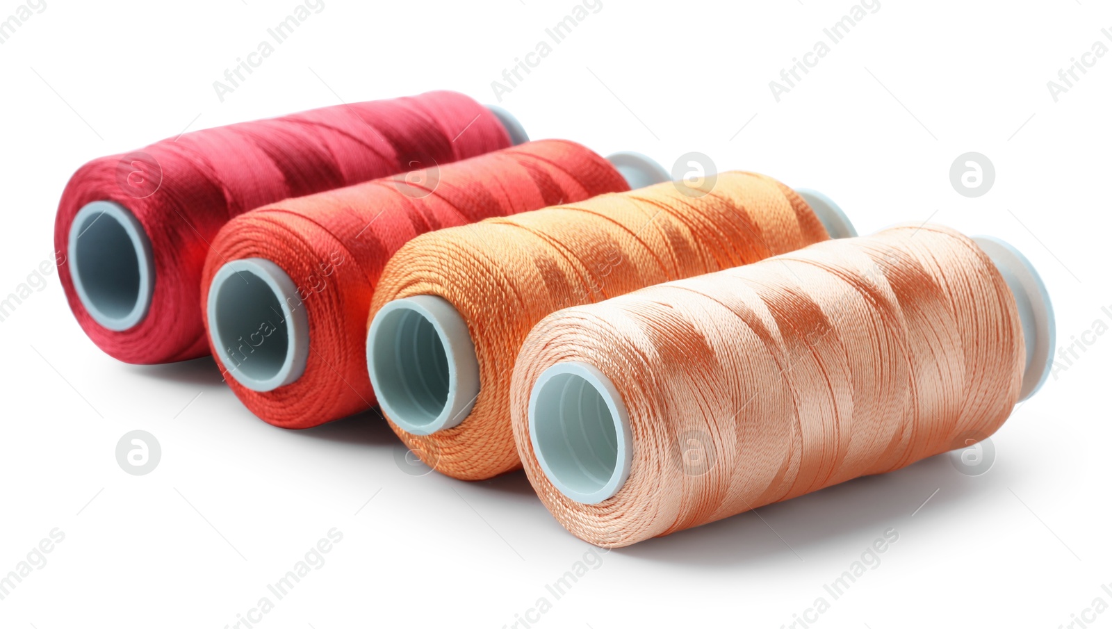 Photo of Spools of colorful sewing threads isolated on white