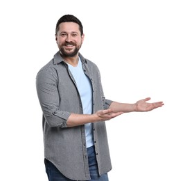 Photo of Happy man welcoming friends or guests on white background