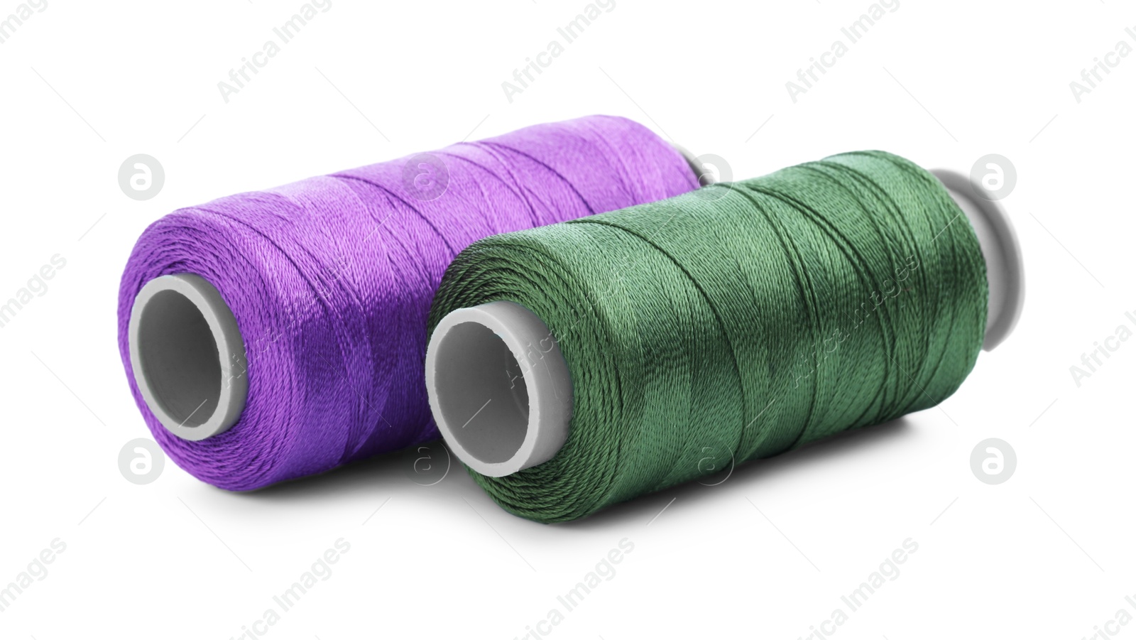 Photo of Spools of bright sewing threads isolated on white