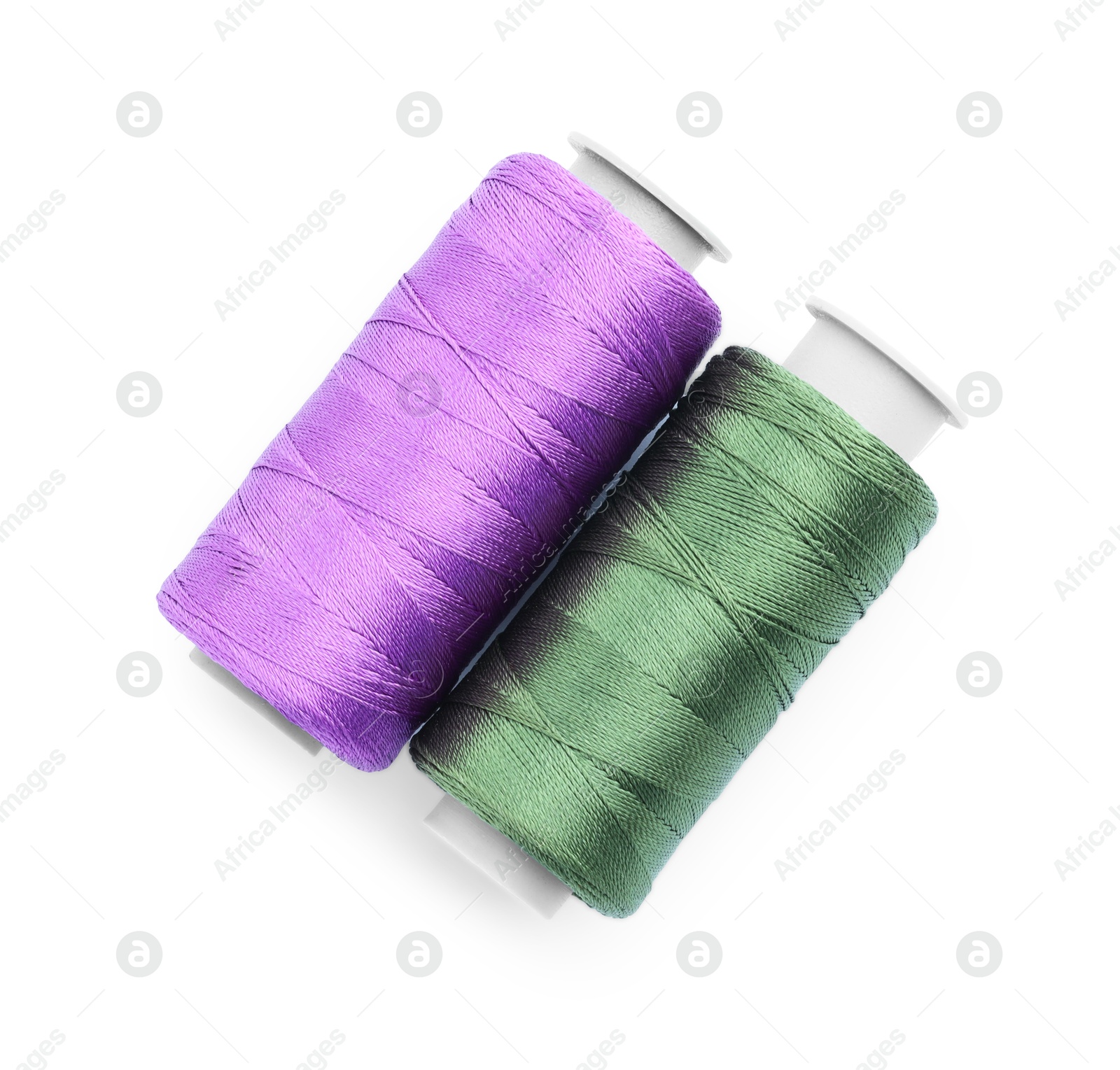 Photo of Spools of bright sewing threads isolated on white, top view