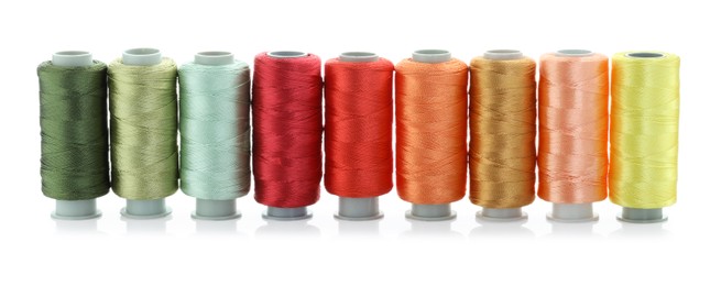 Photo of Spools of bright sewing threads isolated on white