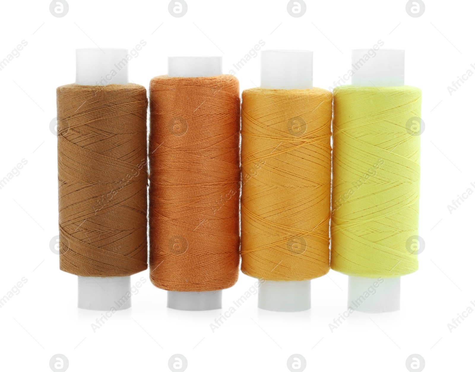 Photo of Spools of bright sewing threads isolated on white