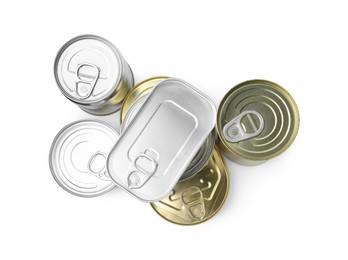 Photo of Many closed tin cans isolated on white, top view