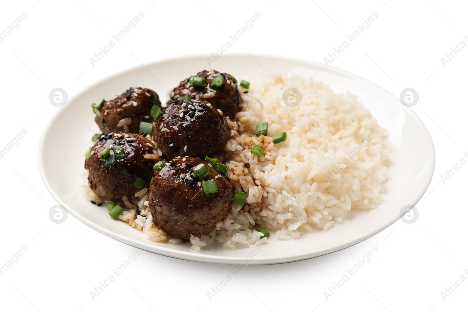 Photo of Delicious rice with meatballs, sauce and green onions isolated on white