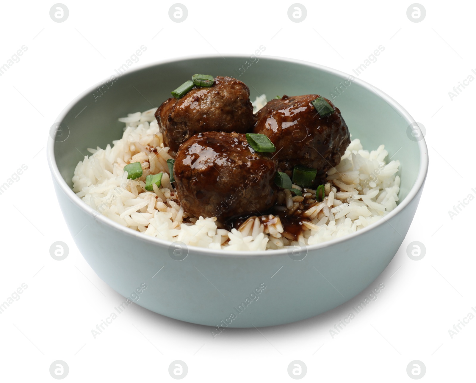 Photo of Delicious rice with meatballs, sauce and green onions in bowl isolated on white