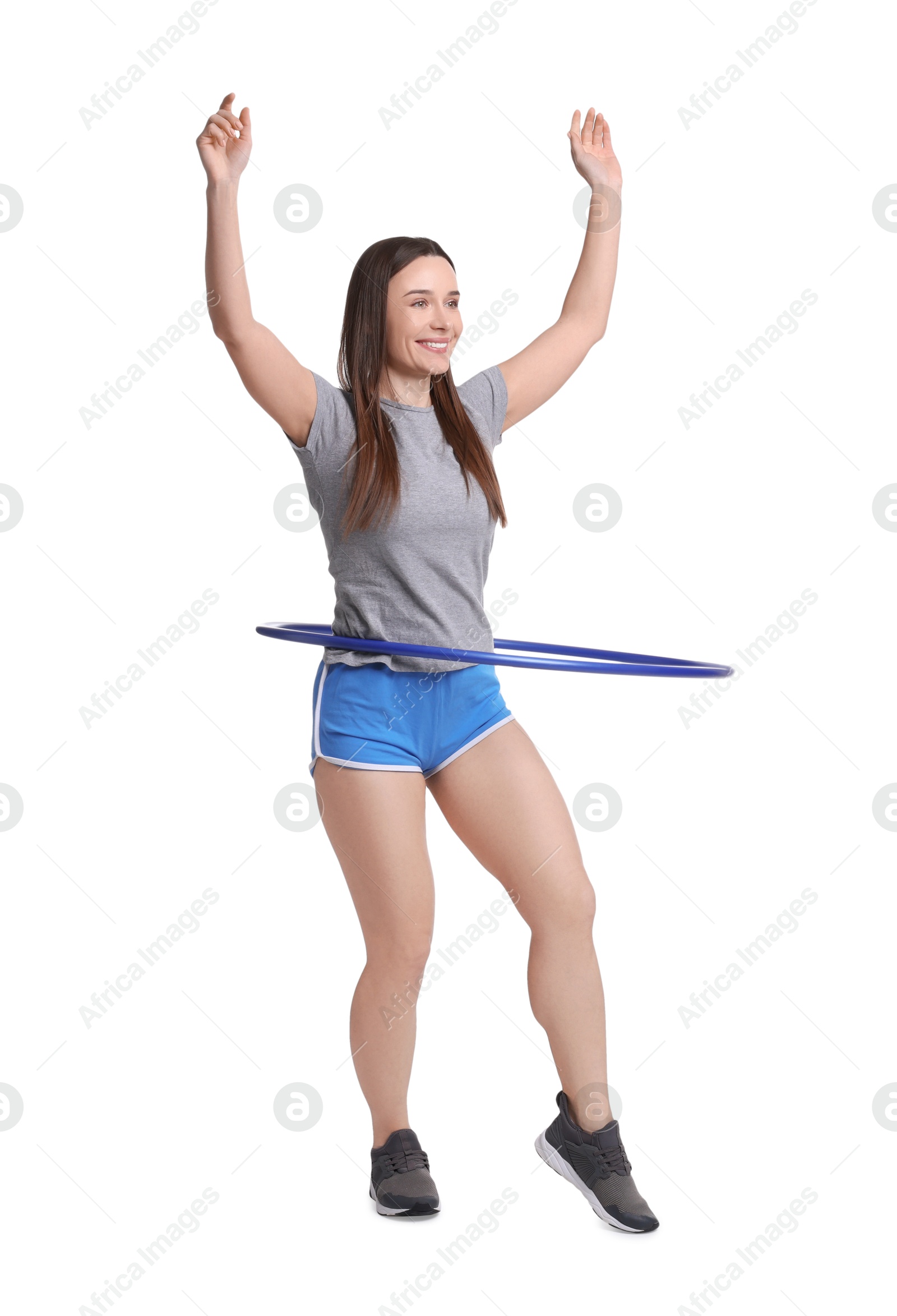 Photo of Smiling woman training with hula hoop on white background