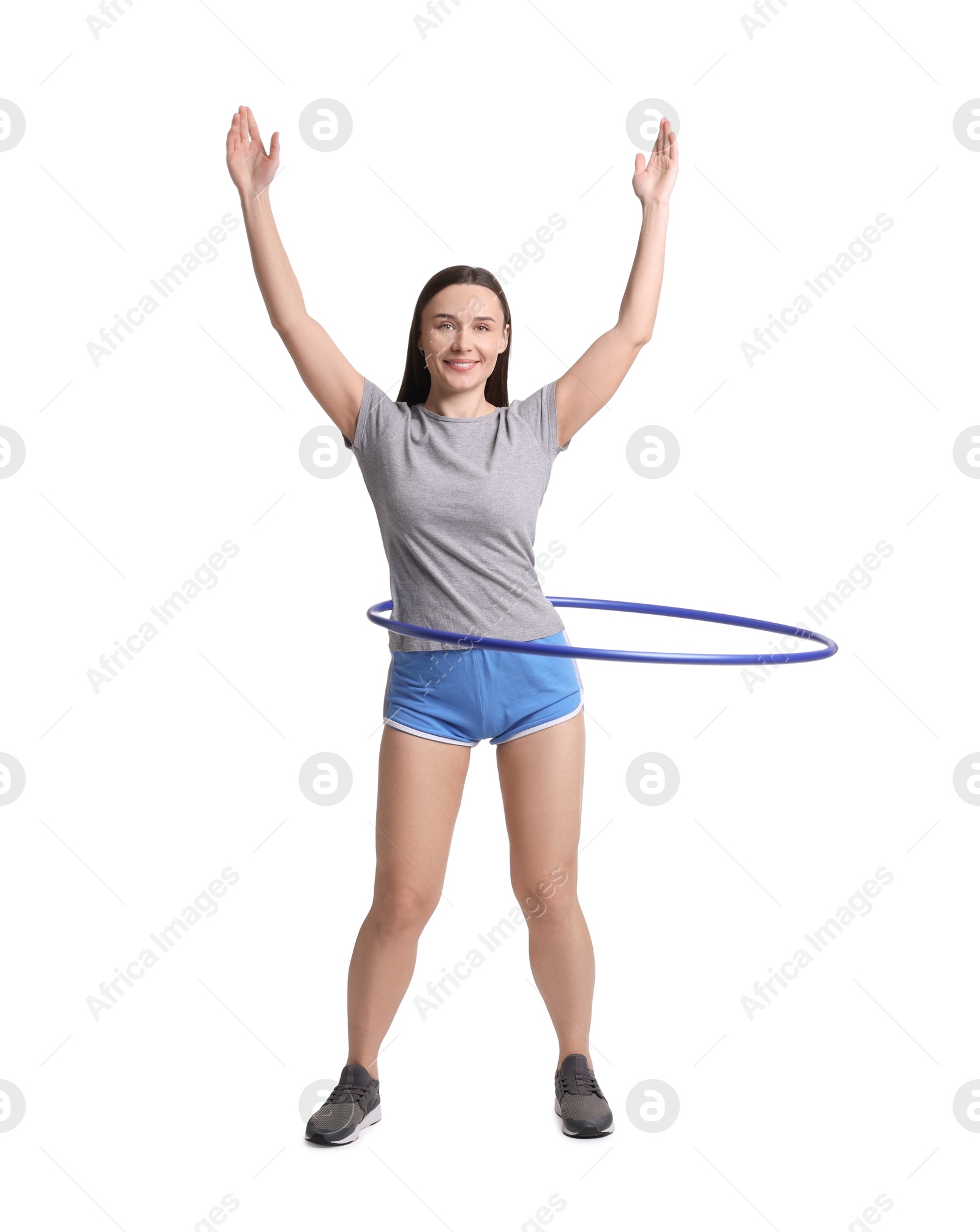 Photo of Smiling woman training with hula hoop on white background