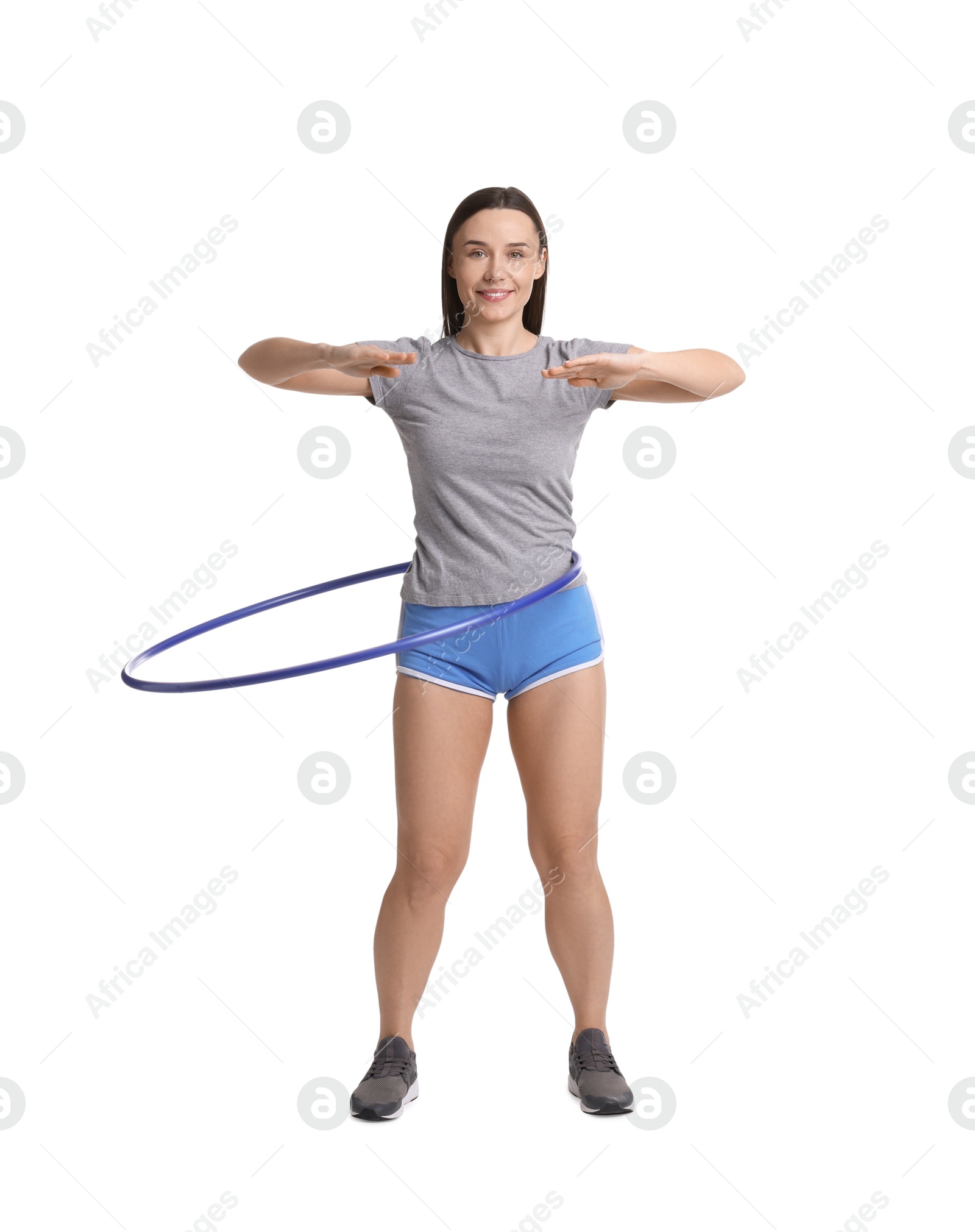 Photo of Smiling woman training with hula hoop on white background