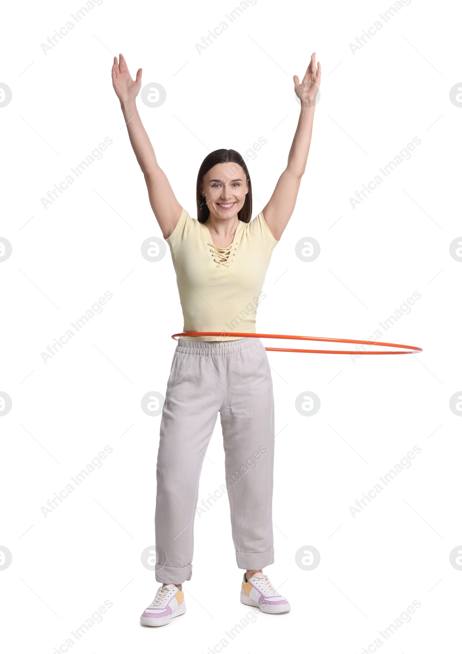 Photo of Smiling woman training with hula hoop on white background