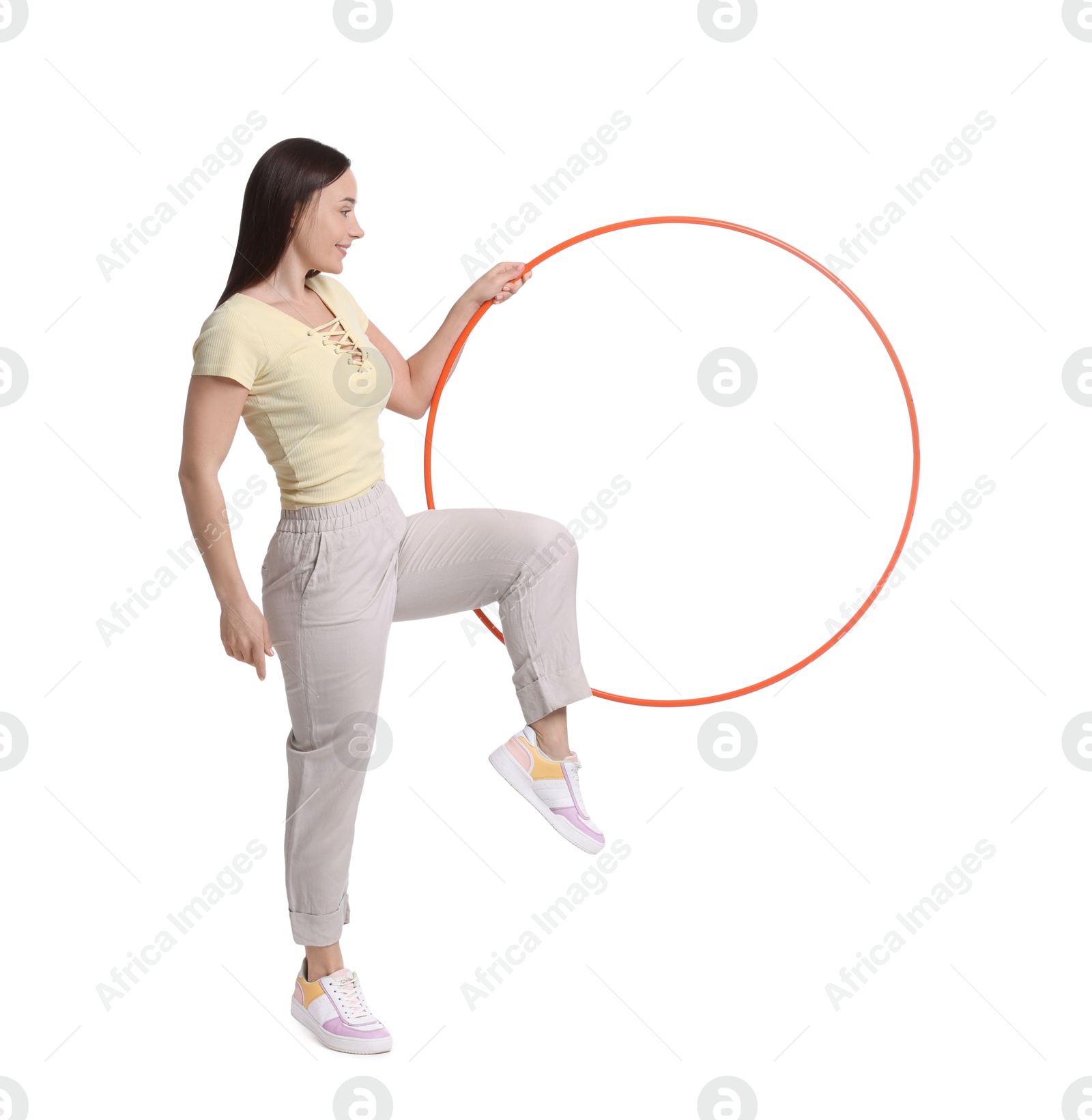 Photo of Smiling woman with hula hoop on white background