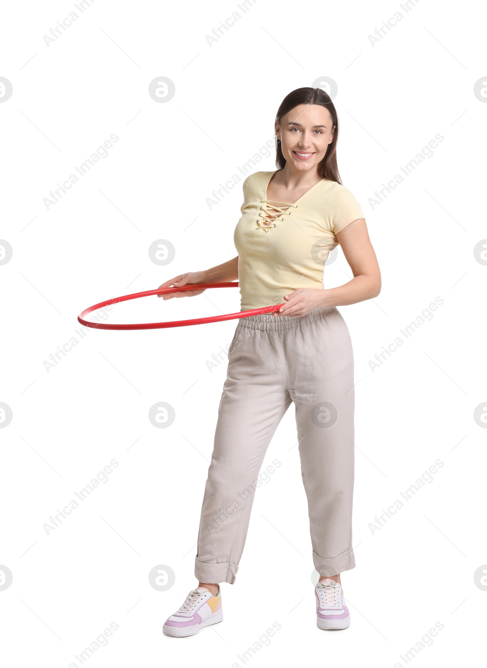 Photo of Smiling woman training with hula hoop on white background