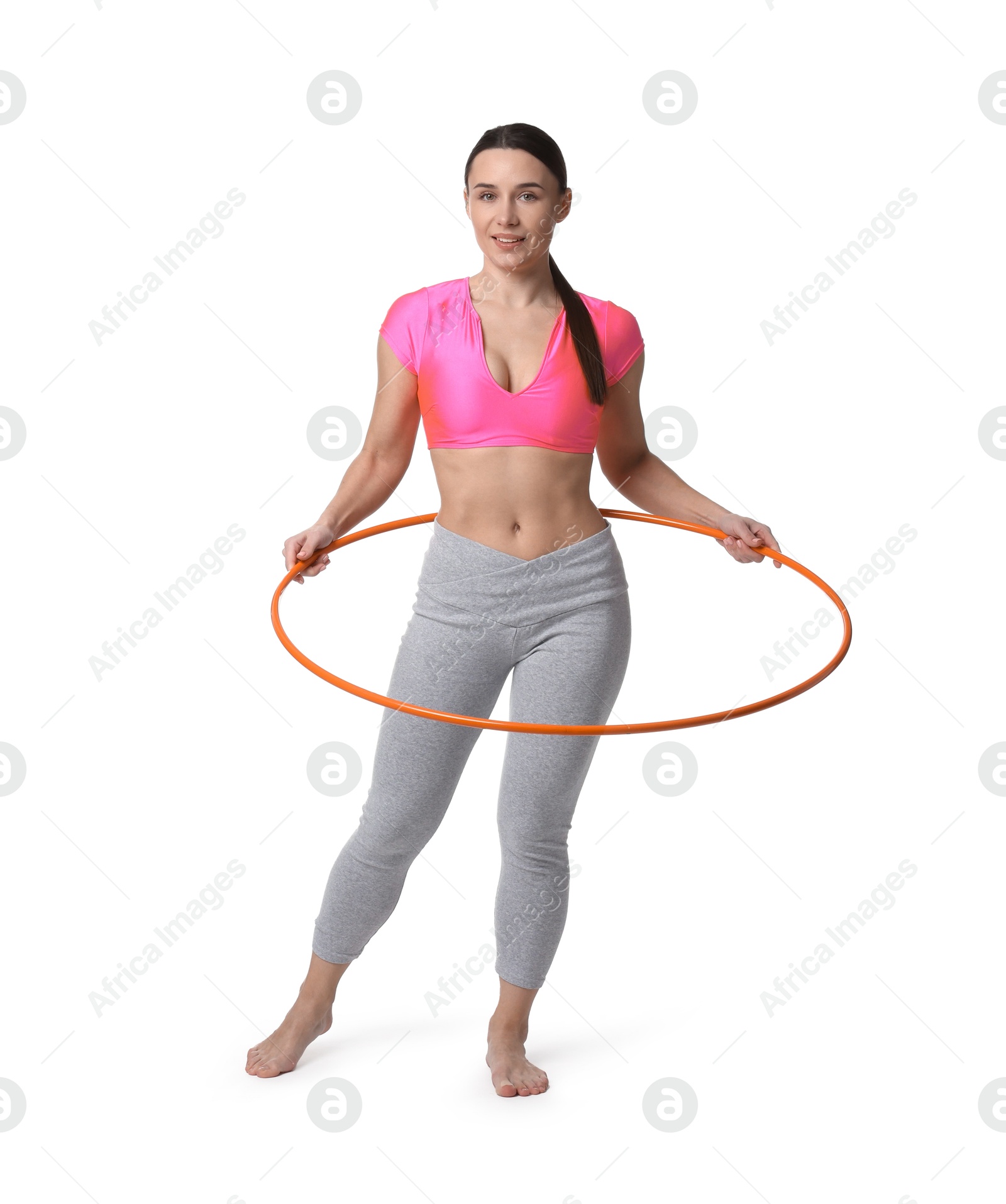 Photo of Smiling woman training with hula hoop on white background