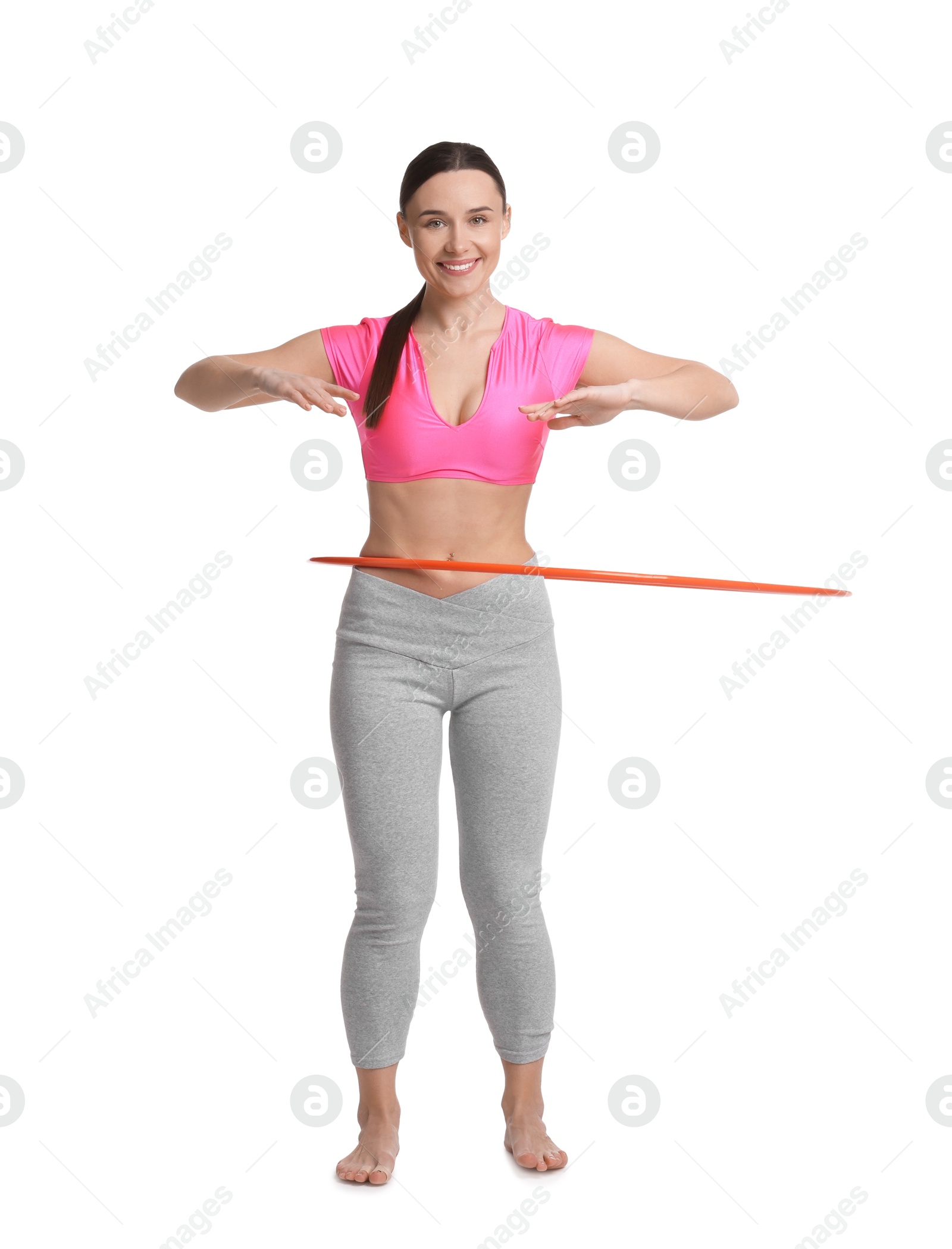 Photo of Smiling woman training with hula hoop on white background