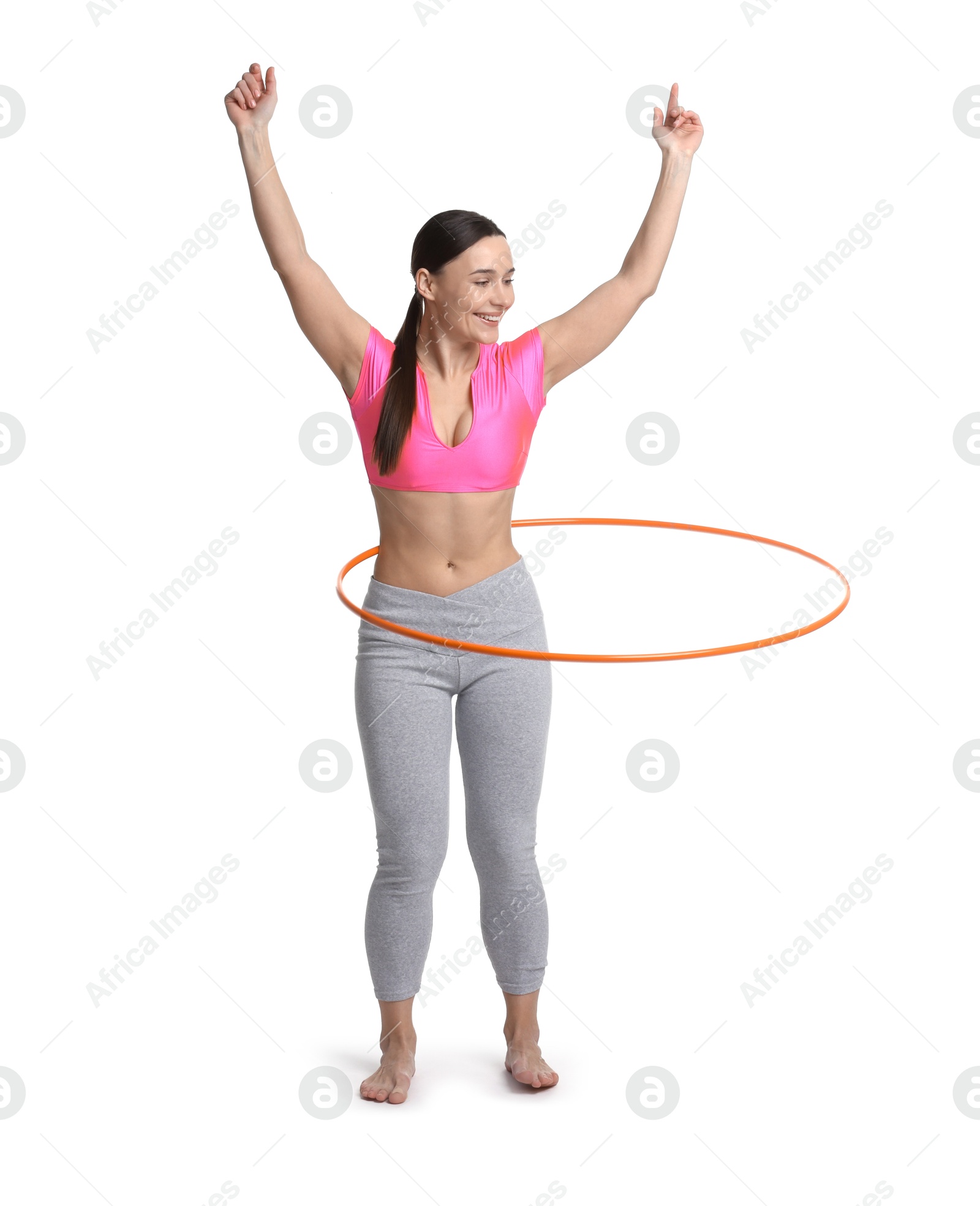 Photo of Smiling woman training with hula hoop on white background