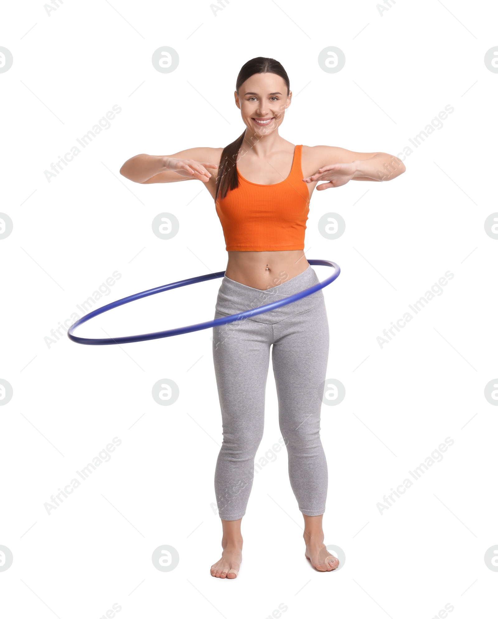 Photo of Smiling woman training with hula hoop on white background