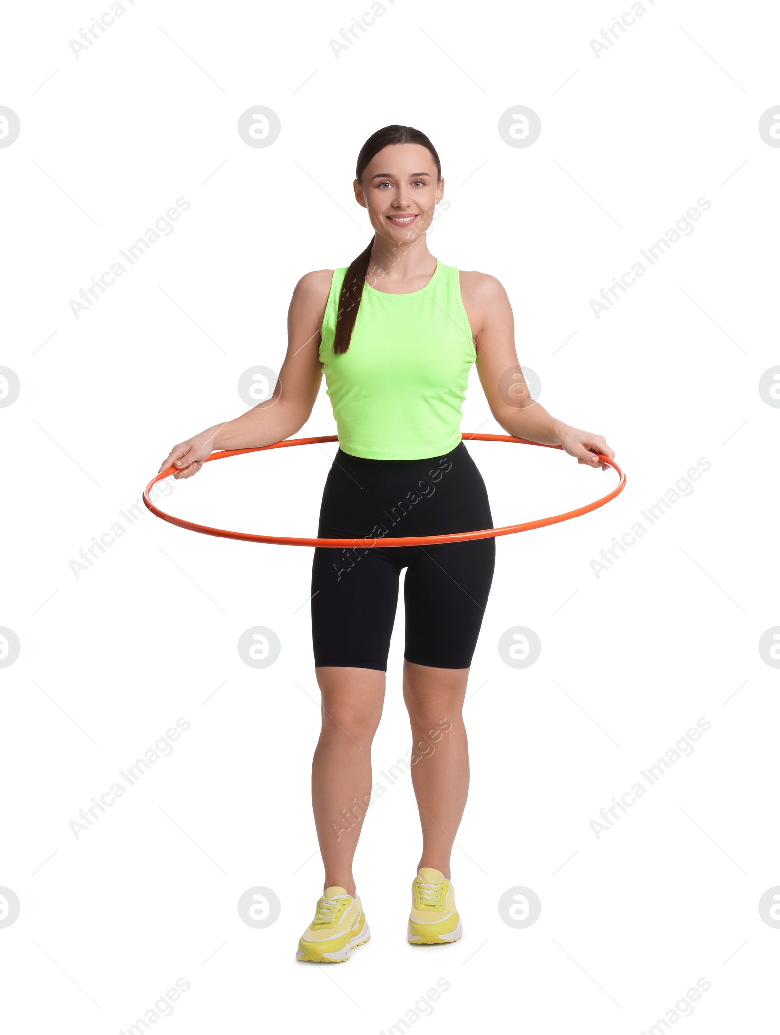 Photo of Smiling woman training with hula hoop on white background