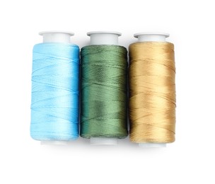 Photo of Spools of bright sewing threads isolated on white, top view