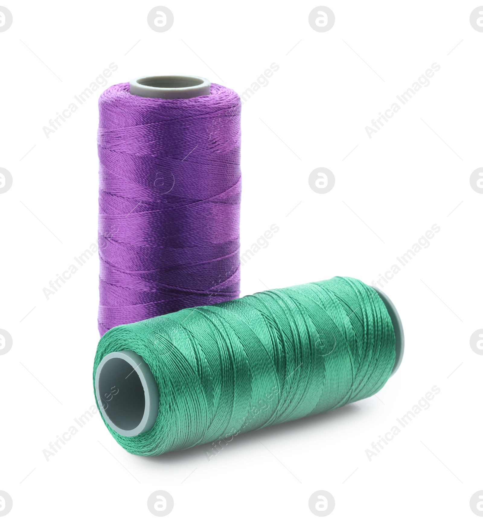 Photo of Spools of bright sewing threads isolated on white