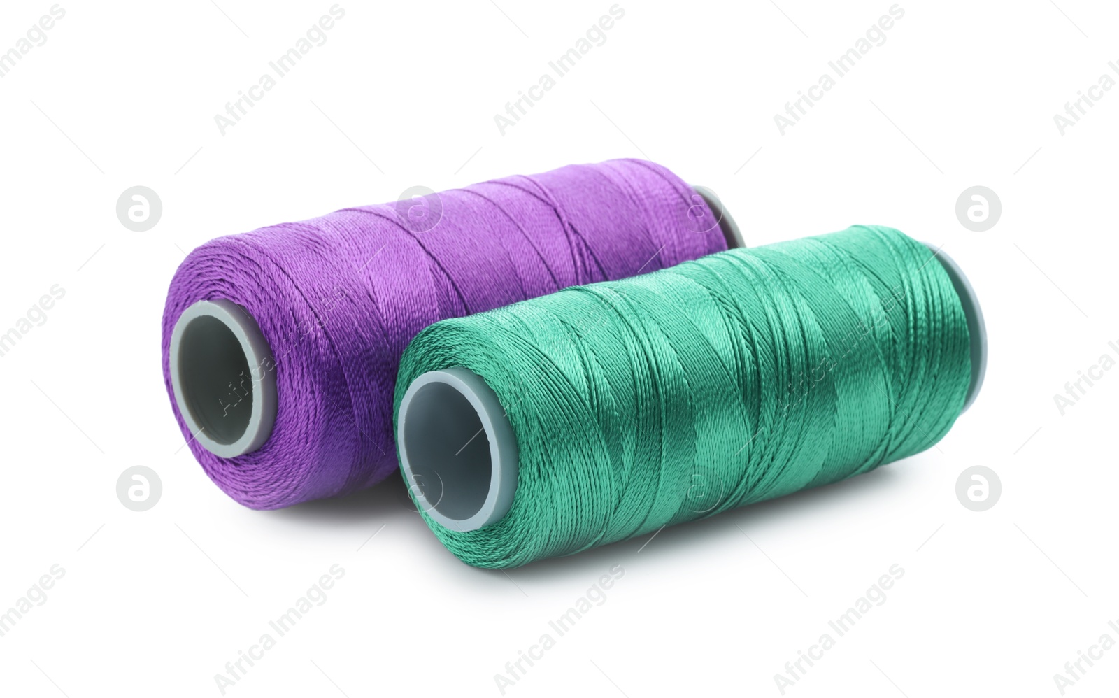 Photo of Spools of bright sewing threads isolated on white