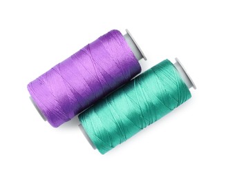 Photo of Spools of bright sewing threads isolated on white, top view