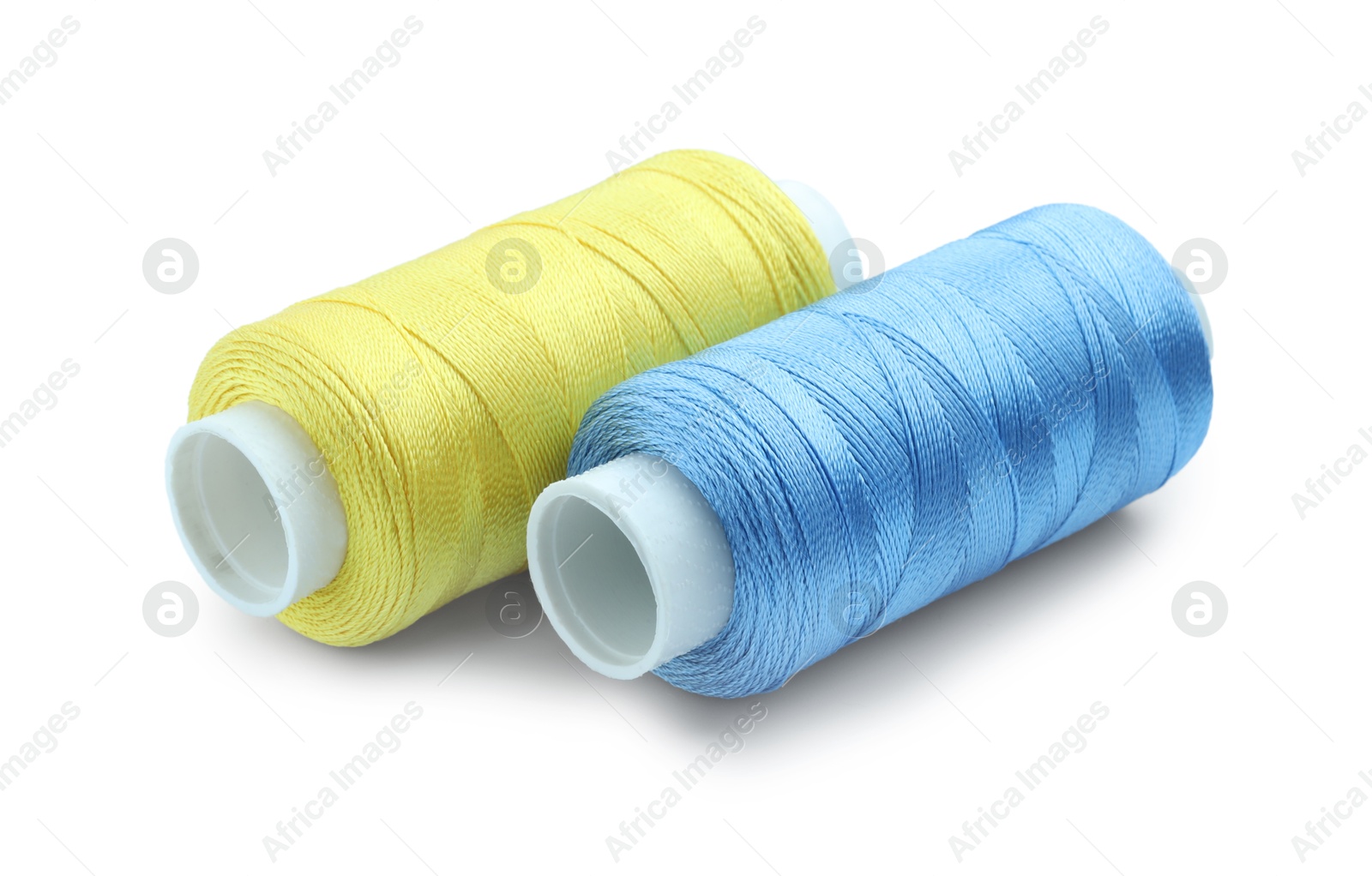 Photo of Spools of bright sewing threads isolated on white