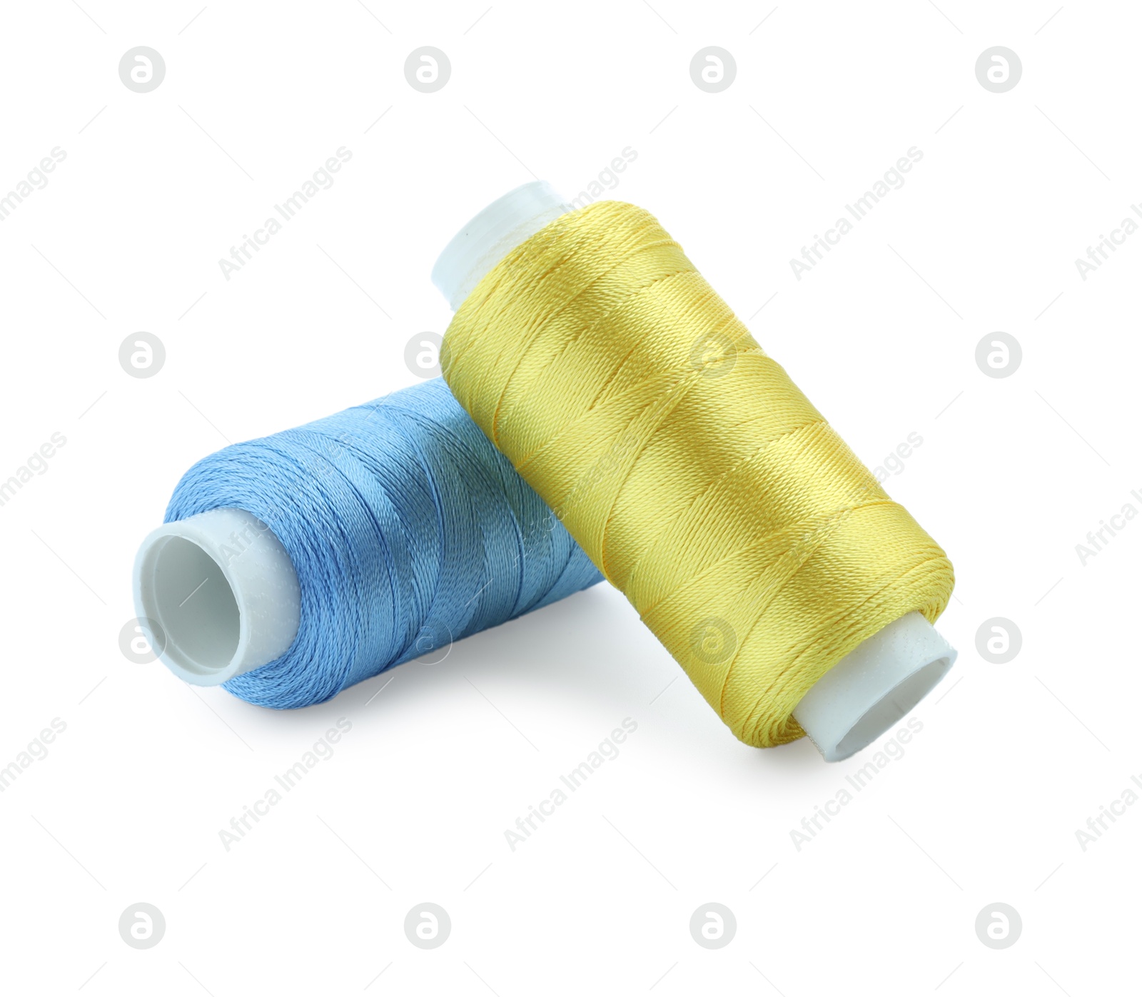 Photo of Spools of bright sewing threads isolated on white