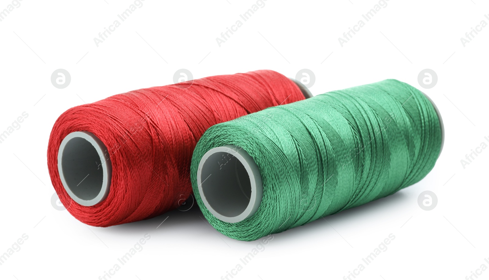 Photo of Spools of bright sewing threads isolated on white