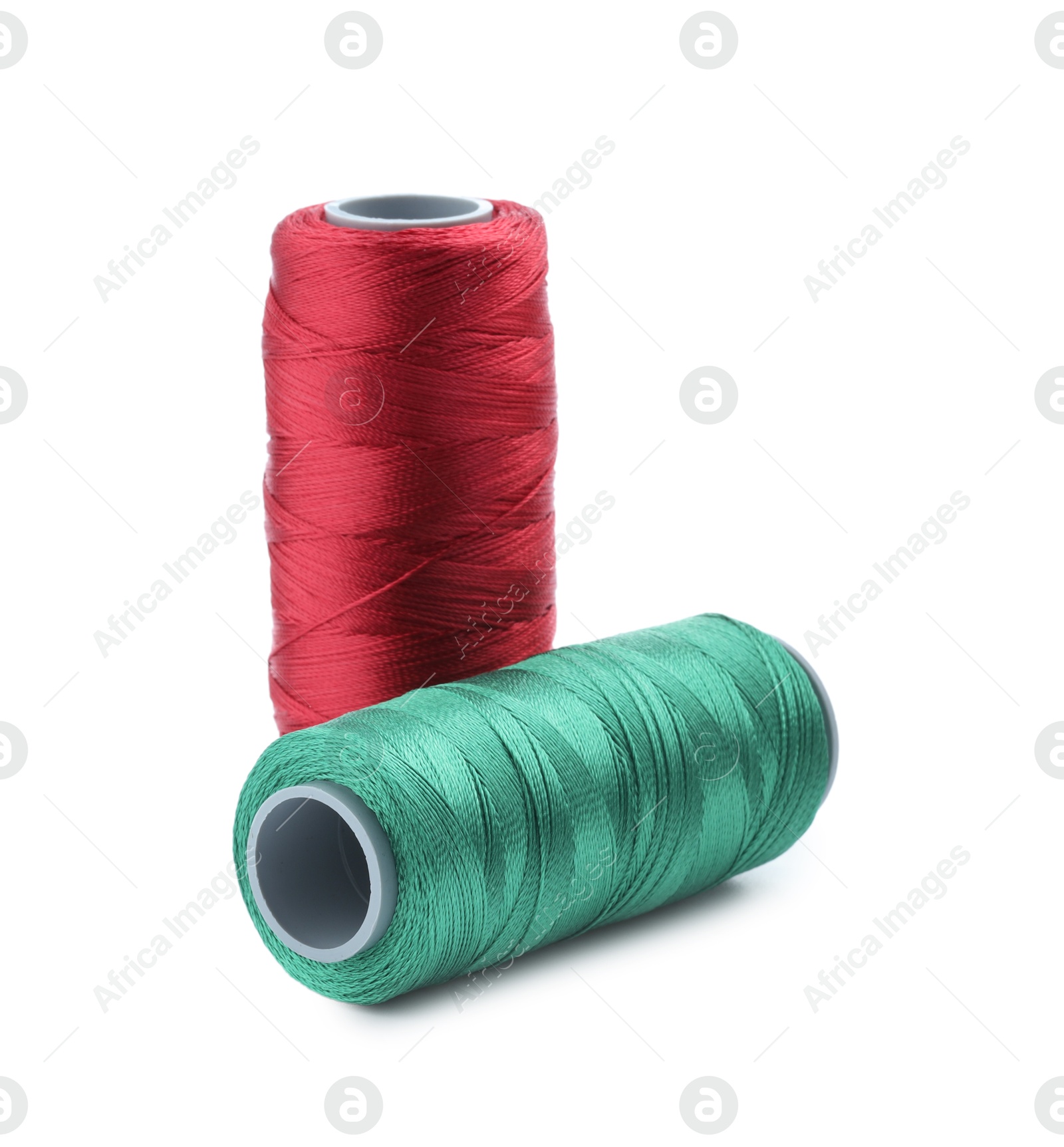 Photo of Spools of bright sewing threads isolated on white