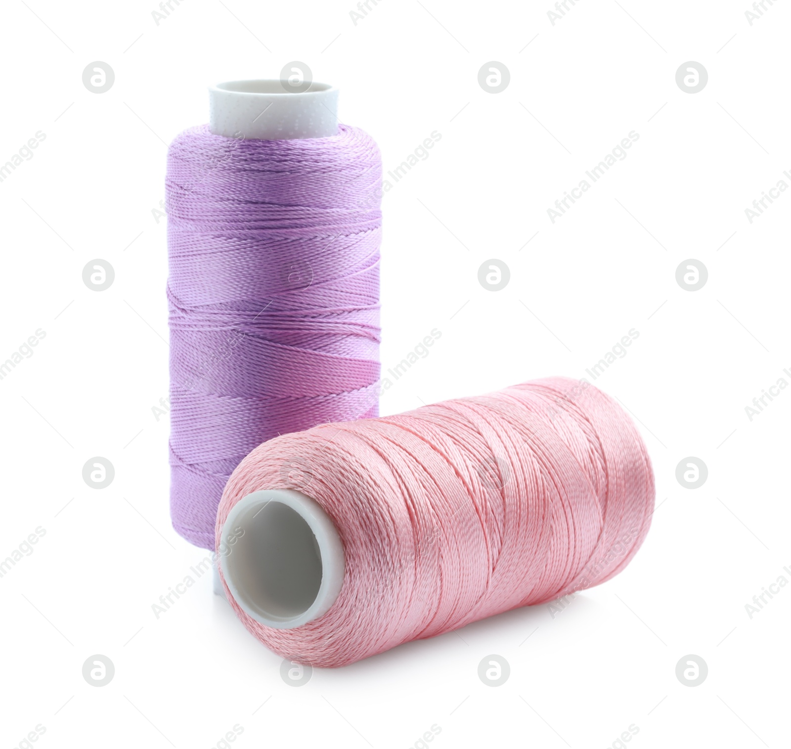 Photo of Spools of bright sewing threads isolated on white