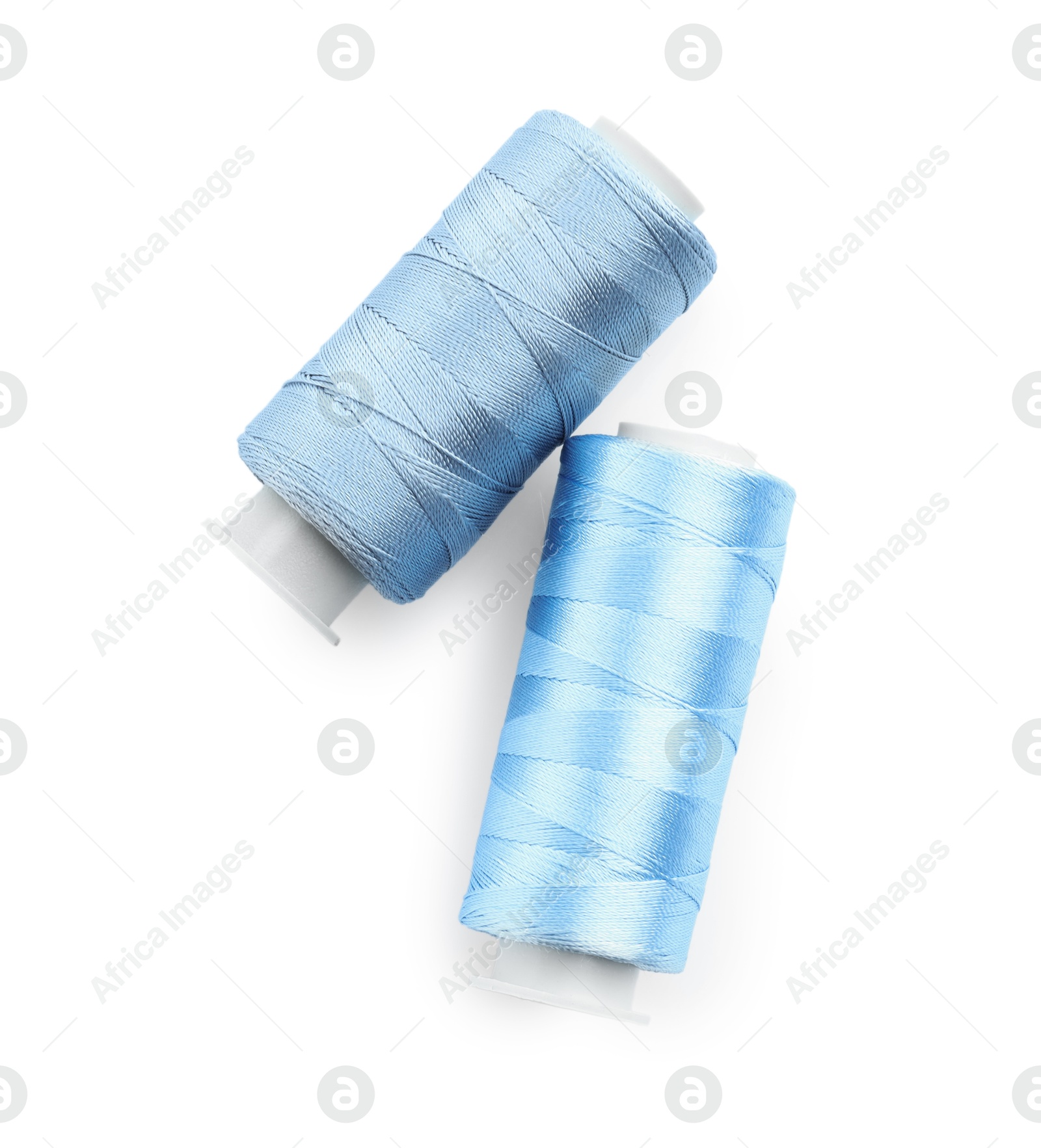 Photo of Spools of bright sewing threads isolated on white, top view