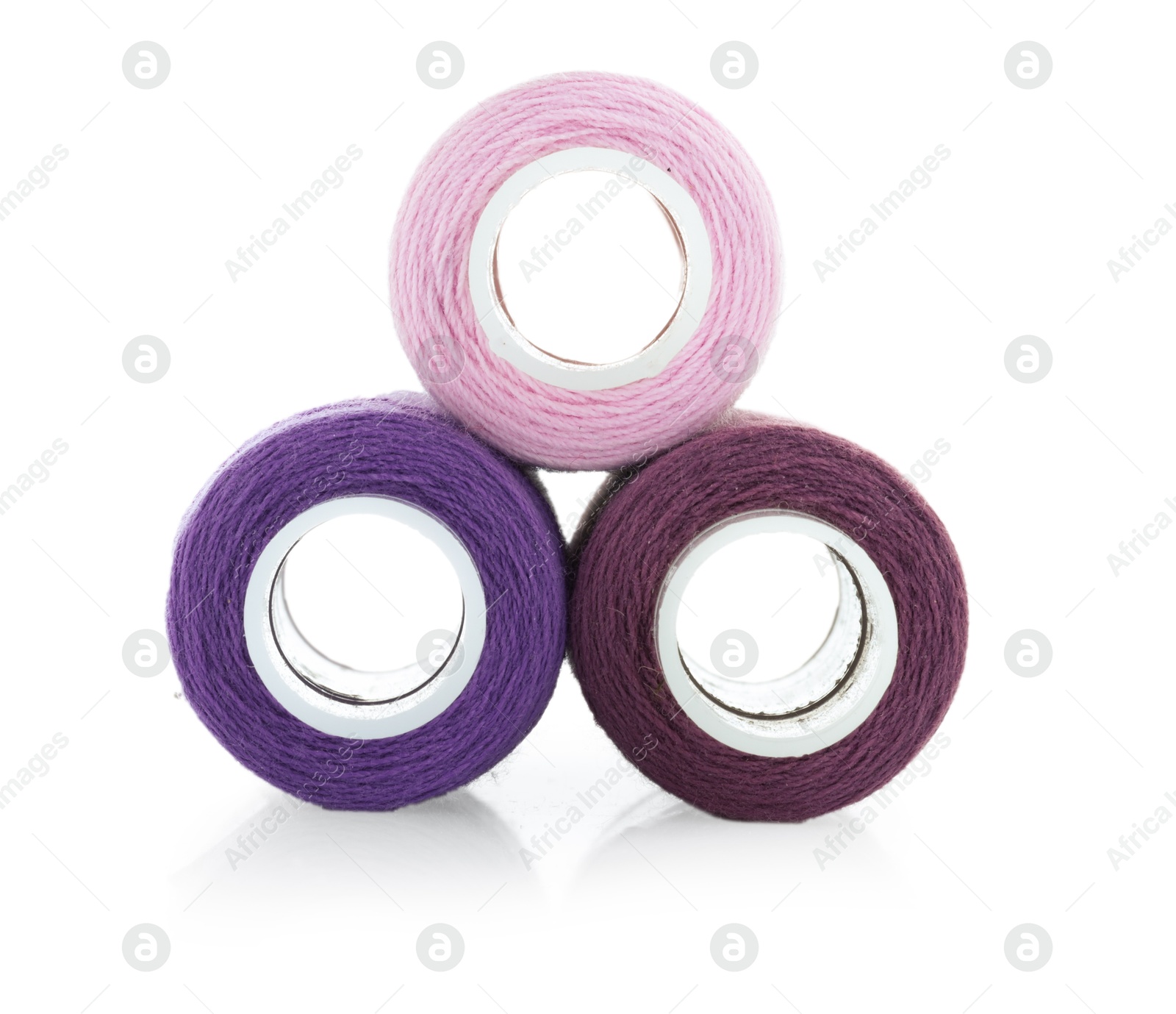 Photo of Spools of bright sewing threads isolated on white