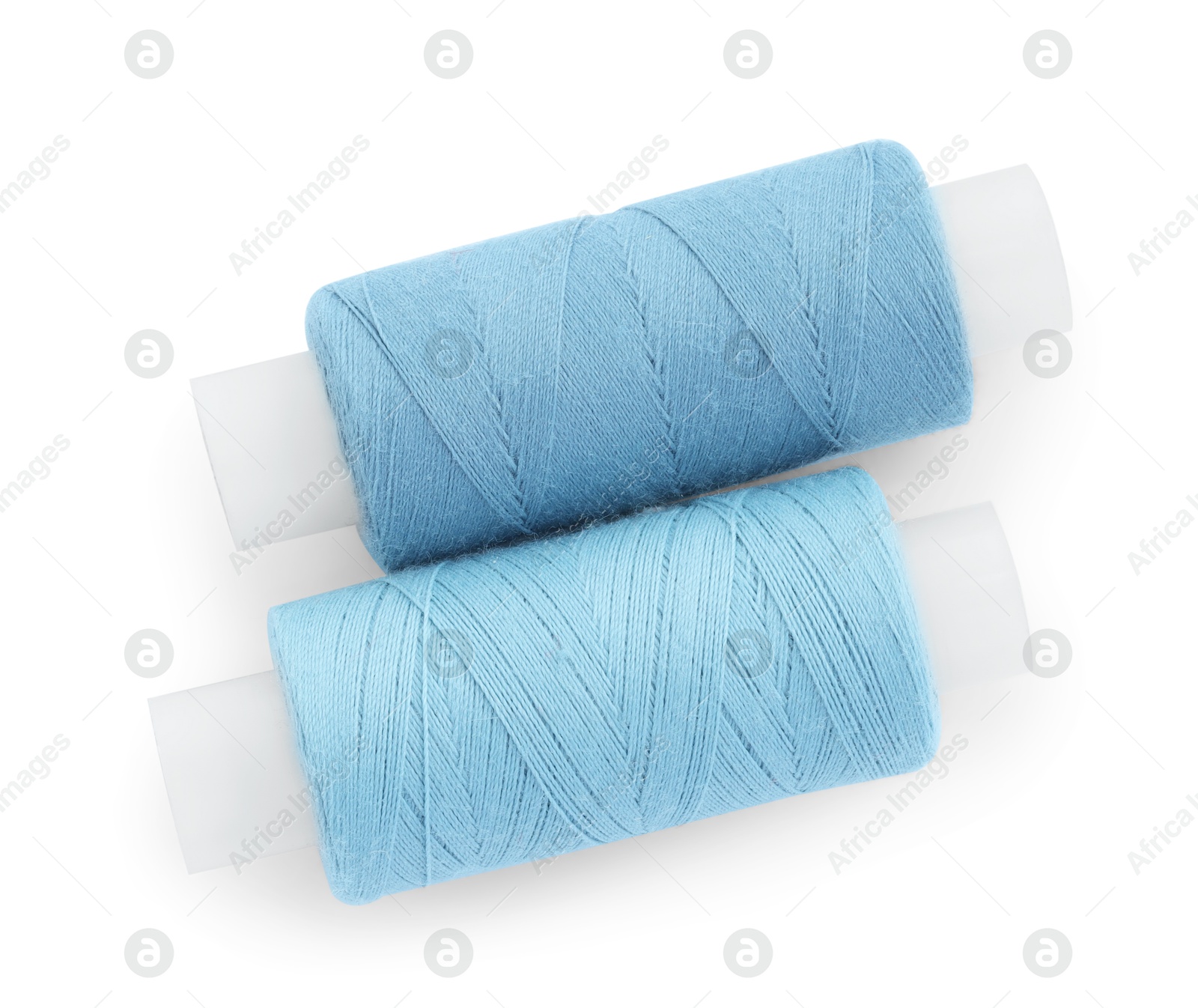 Photo of Spools of bright sewing threads isolated on white, top view