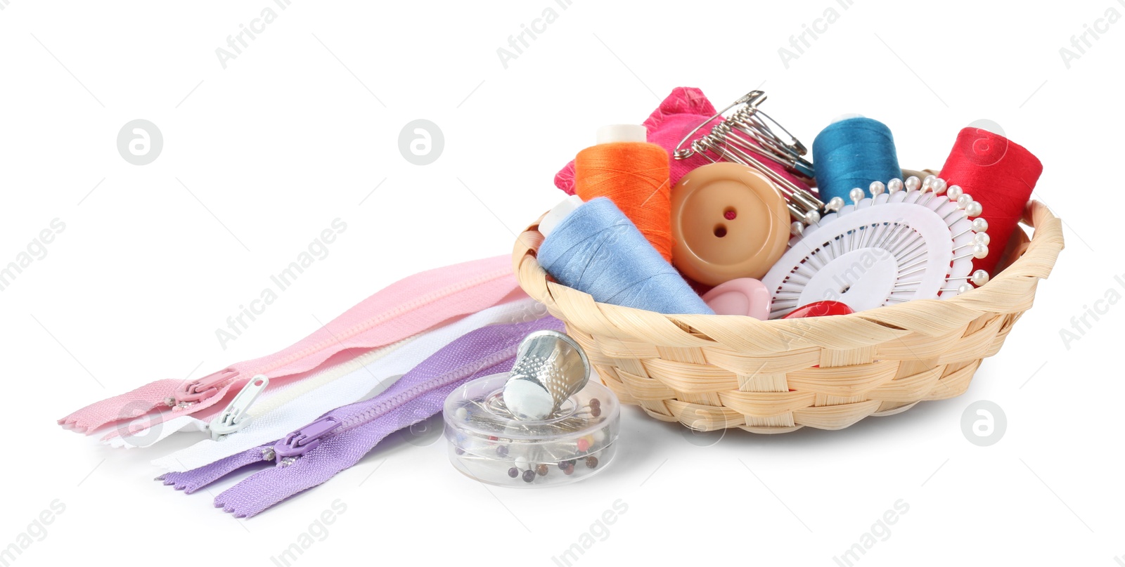 Photo of Basket with sewing supplies isolated on white