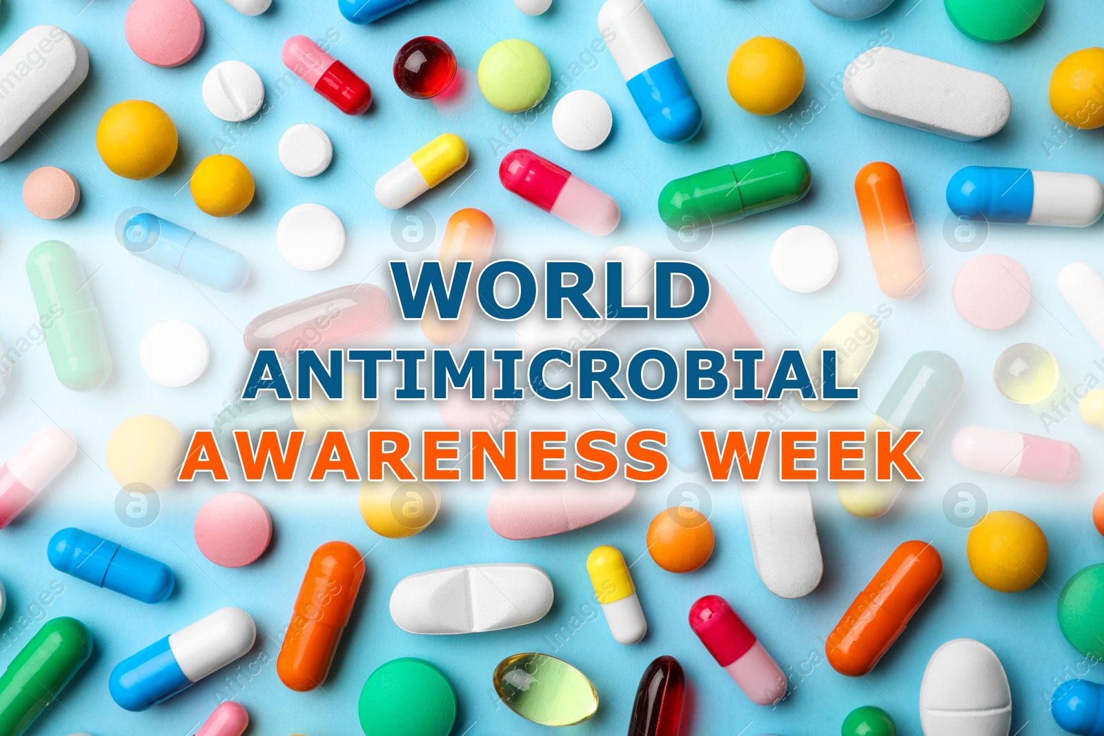 Image of World antimicrobial awareness week. Many different pills on light blue background, flat lay