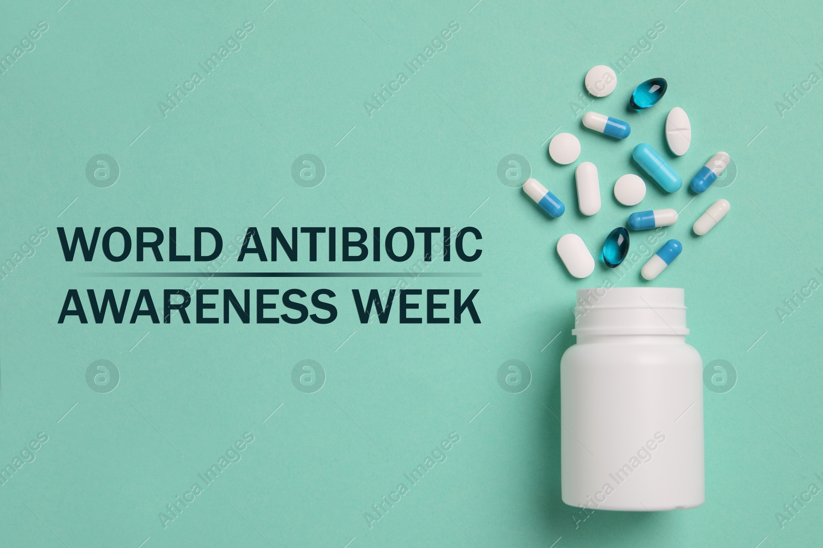 Image of World antibiotic awareness week. Bottle and scattered pills on turquoise background, top view