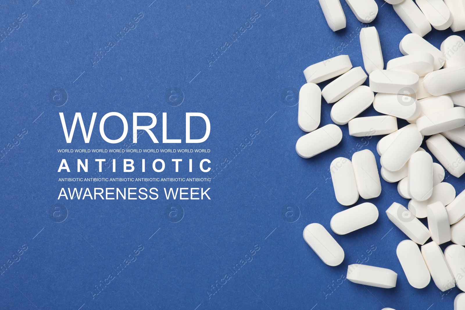 Image of World antibiotic awareness week. Many white pills on blue background, flat lay