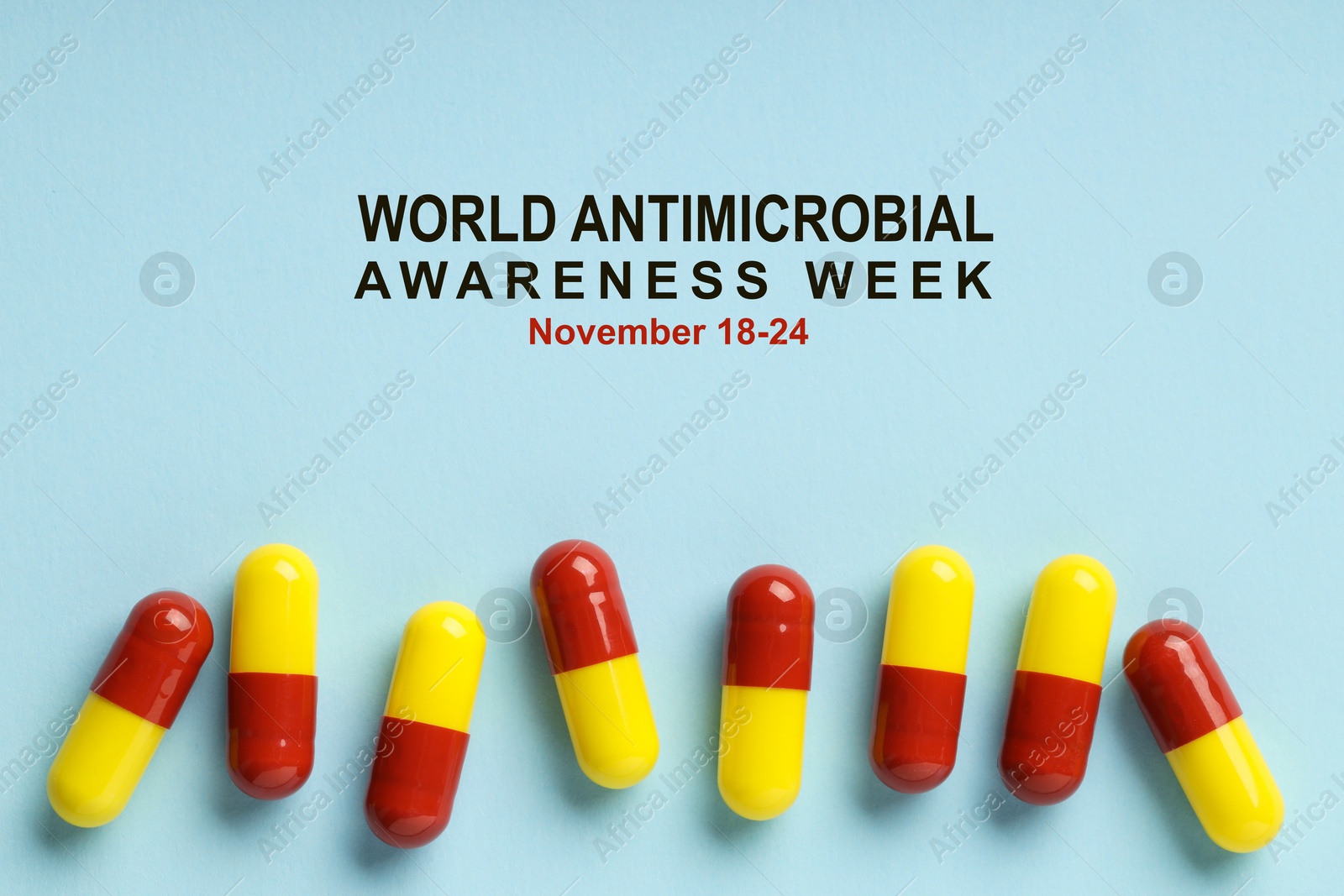 Image of World antimicrobial awareness week. Many pills on light blue background, flat lay