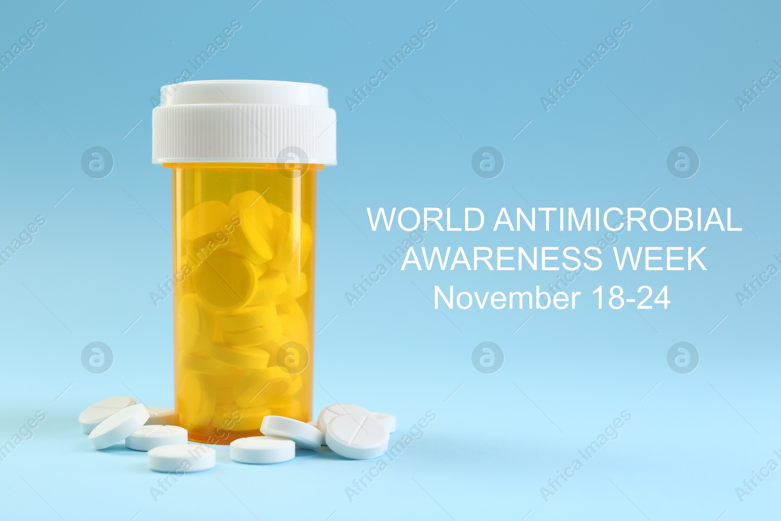 Image of World antimicrobial awareness week. Bottle and scattered pills on light blue background