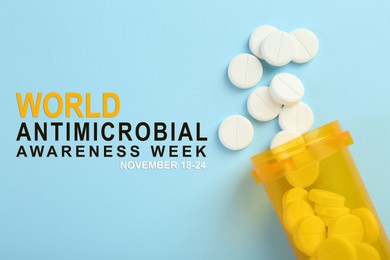 Image of World antimicrobial awareness week. Bottle and scattered pills on light blue background, top view