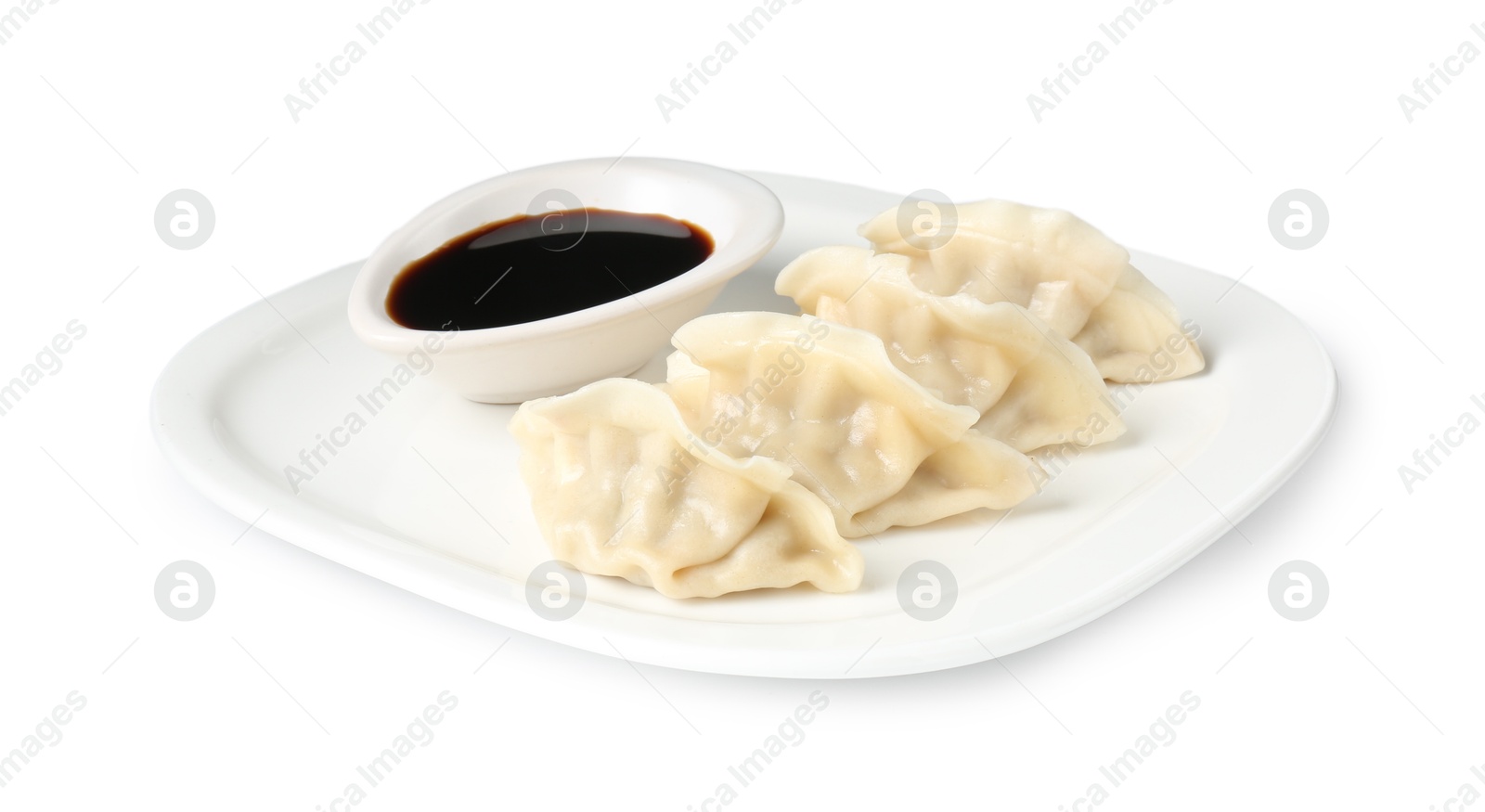 Photo of Tasty gyoza (dumplings) and soy sauce isolated on white