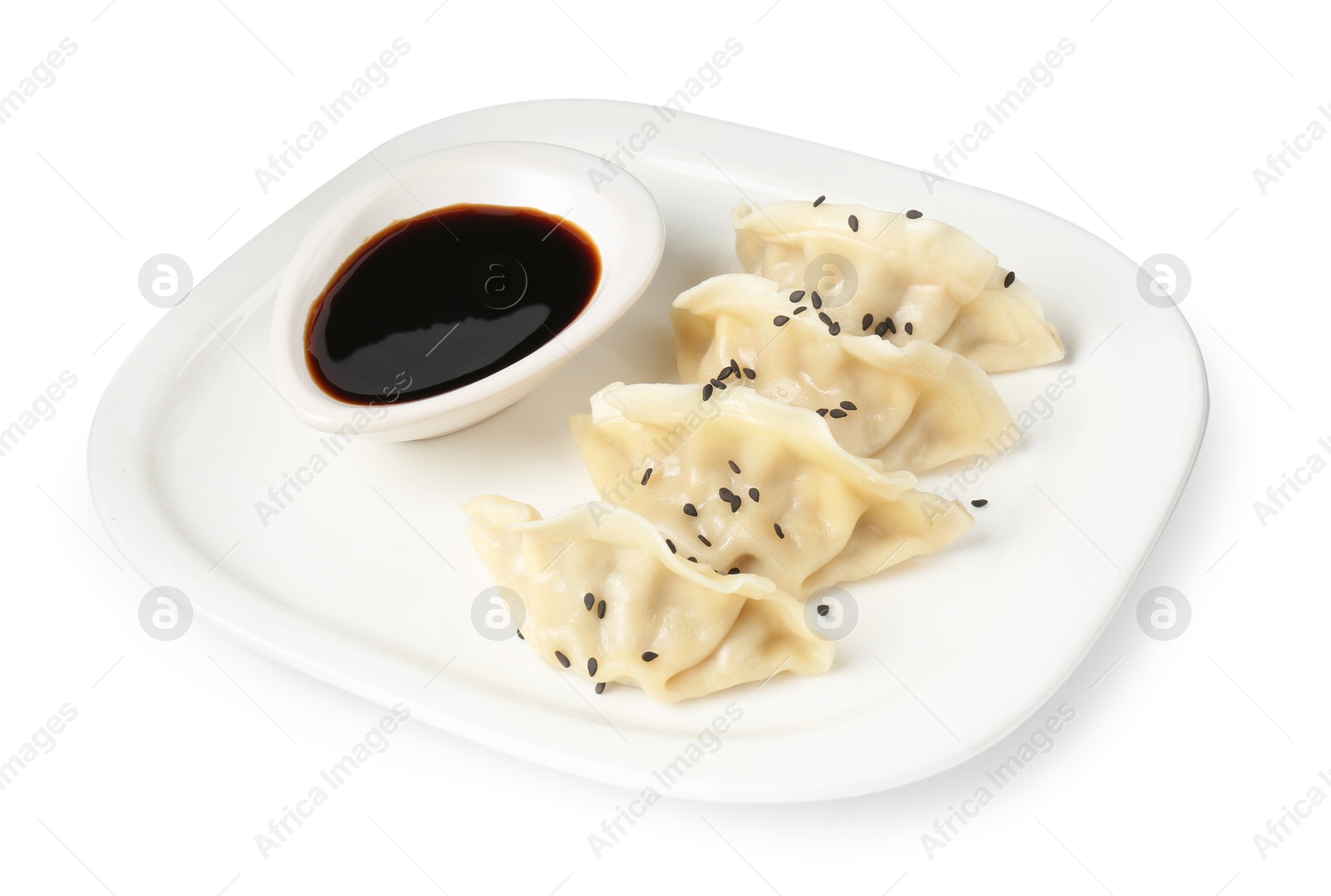 Photo of Tasty gyoza (dumplings) and soy sauce isolated on white