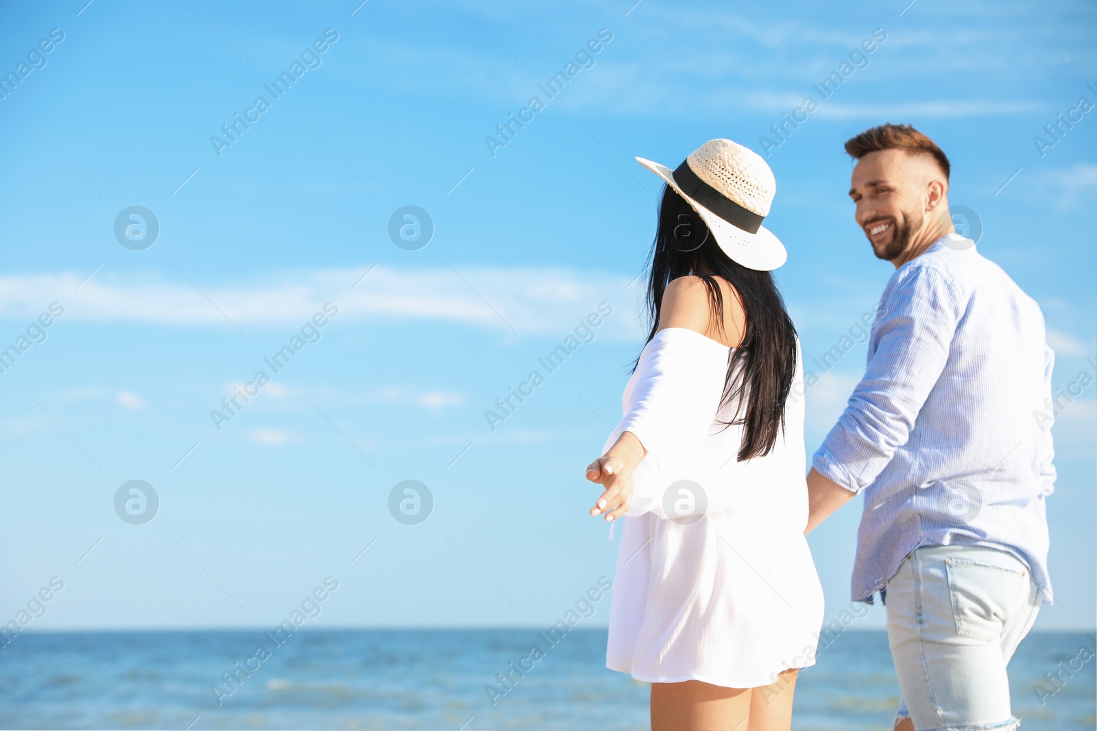 Photo of Happy young couple at beach on sunny day