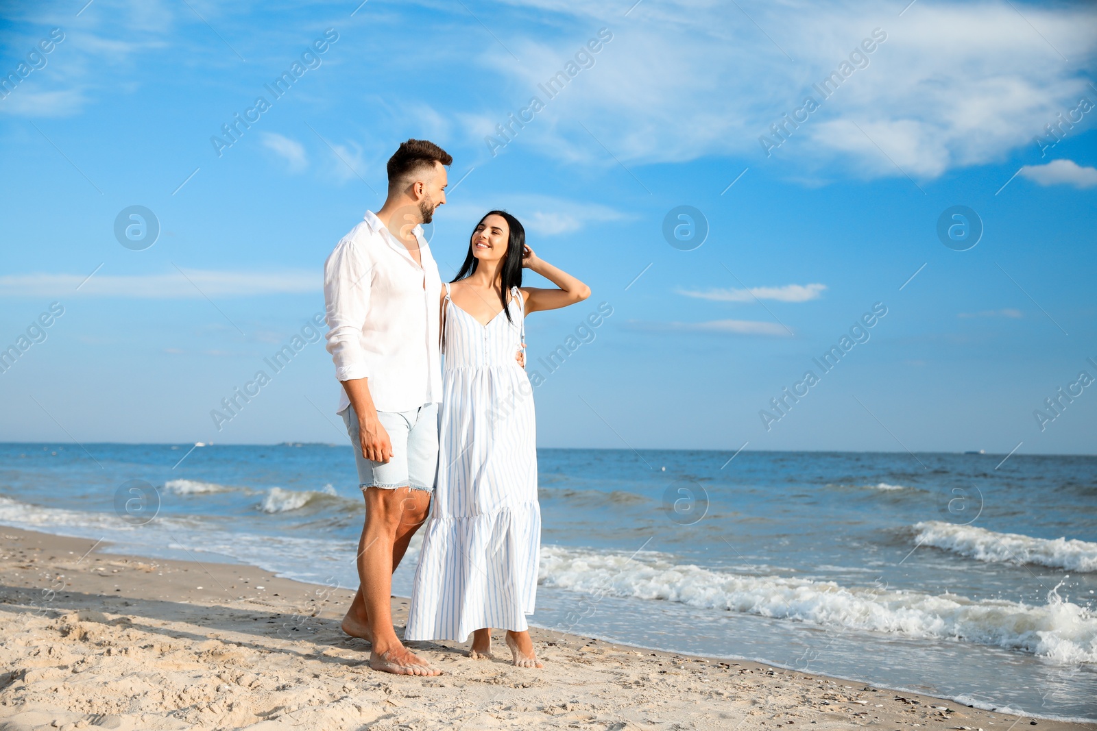 Photo of Happy young couple at beach on sunny day