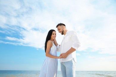 Photo of Happy young couple at beach on sunny day