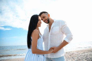 Photo of Happy young couple at beach on sunny day