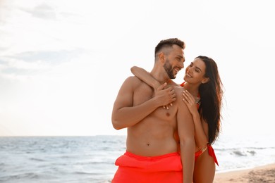 Photo of Happy young couple on beach on sunny day