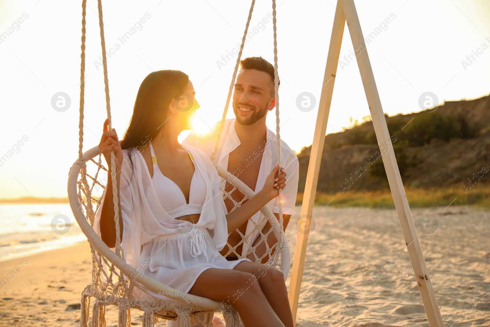 Photo of Happy young couple on beach at sunset