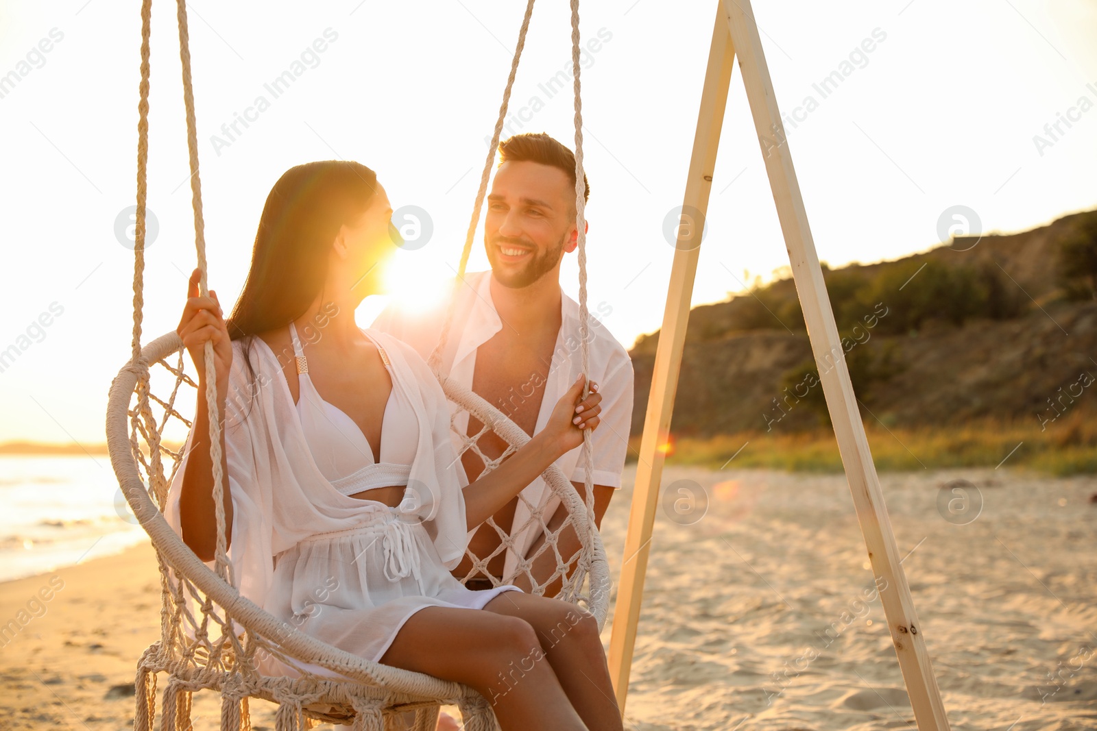 Photo of Happy young couple on beach at sunset