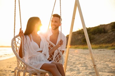 Photo of Happy young couple on beach at sunset