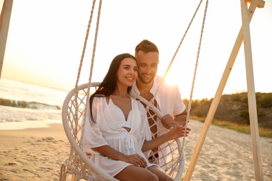 Photo of Happy young couple on beach at sunset